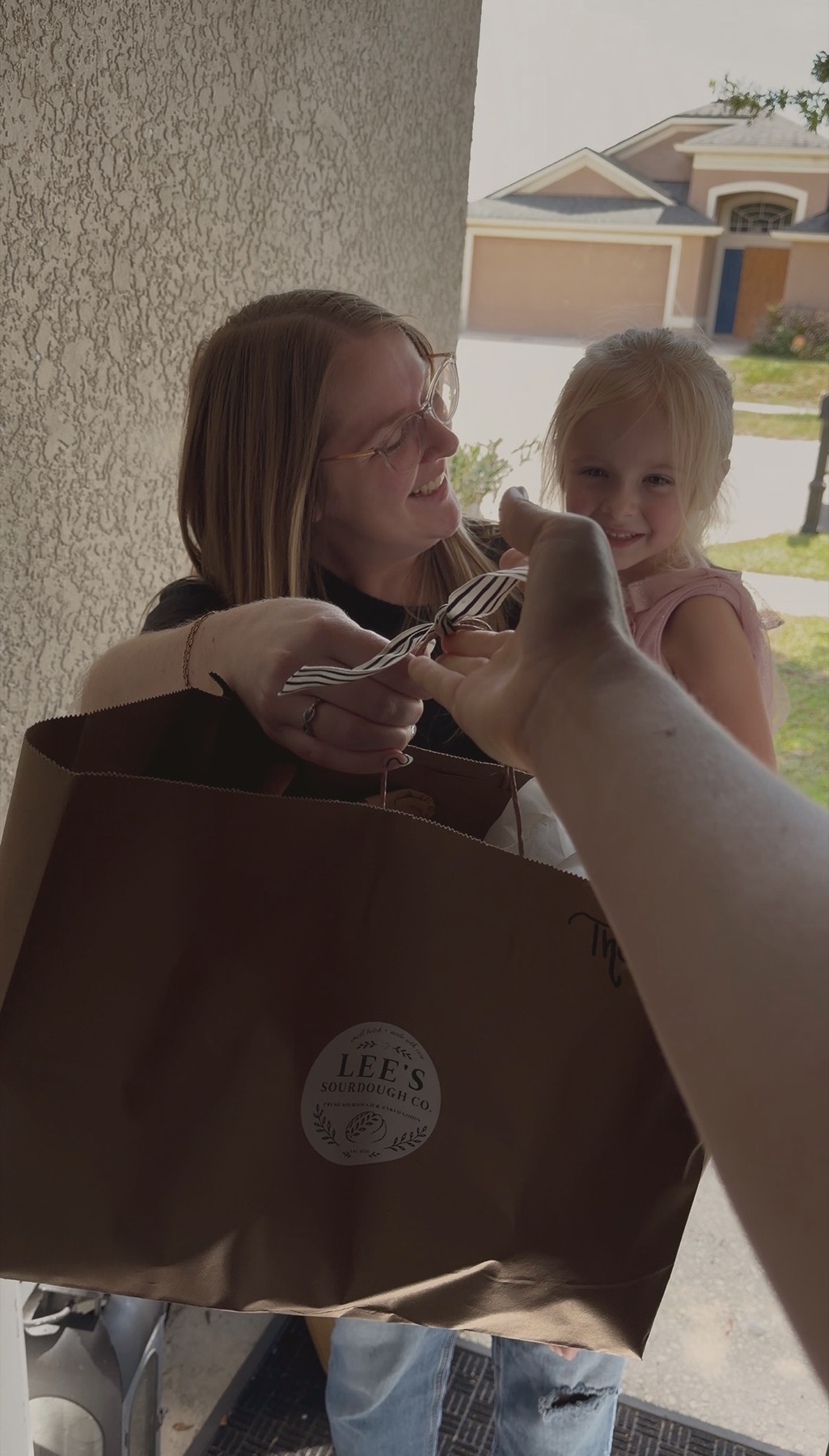 Sharing Lee's Sourdough Co. bread with a customer and her child